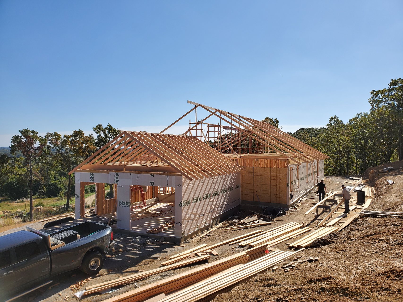 Custom home framing on a wooded Green Country lot during construction