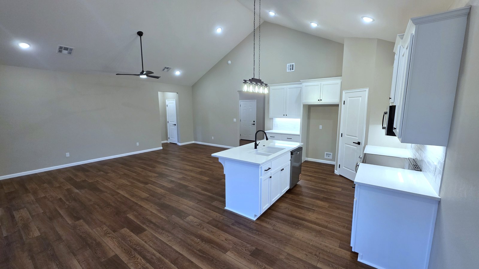 Custom kitchen remodel with white island and hardwood floors