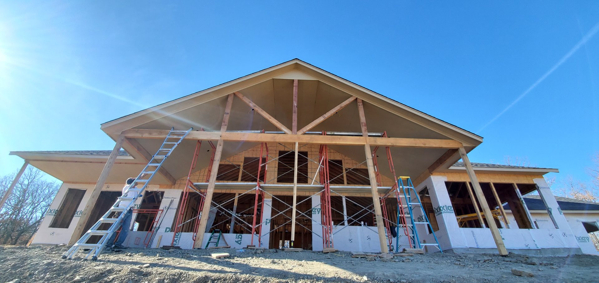 Timber truss and porch framing on a custom Green Country home under construction