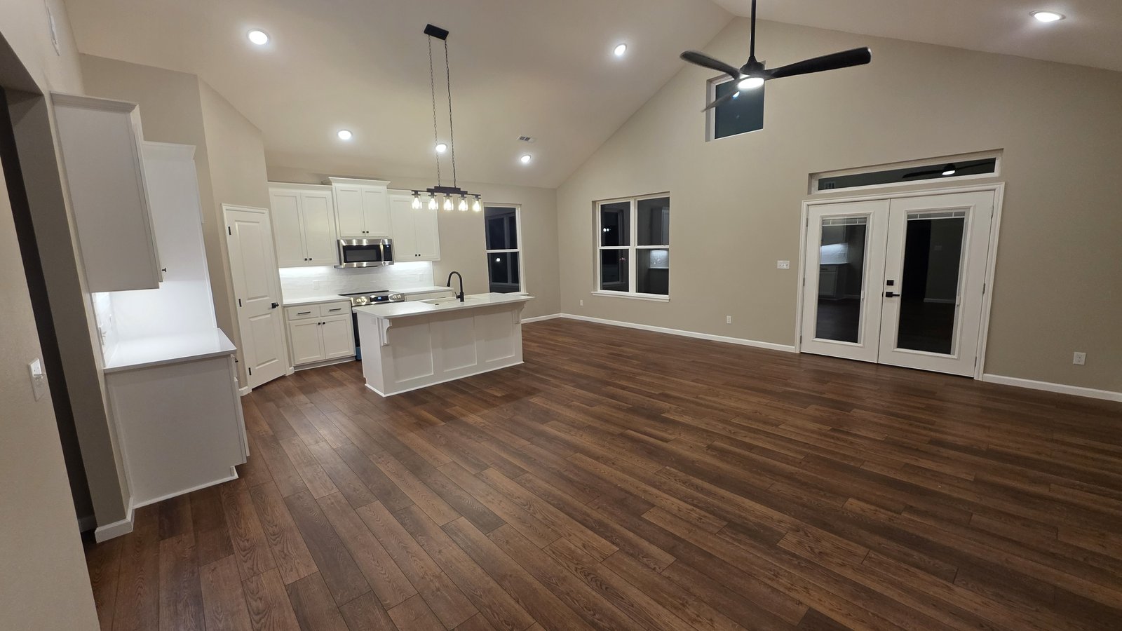 Open plan kitchen and living room at dusk