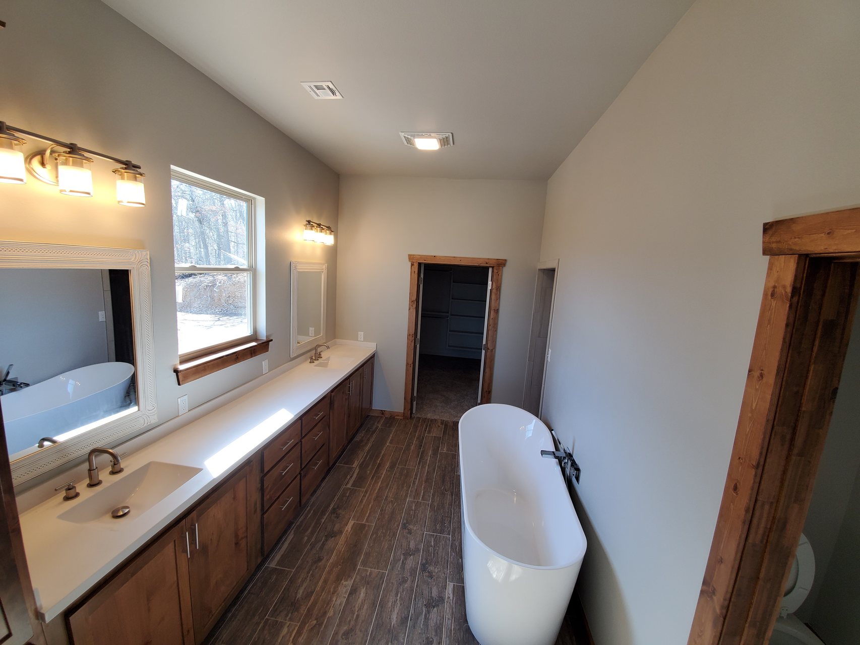 Primary bathroom with double vanity and freestanding tub